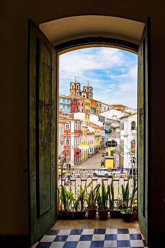 Open door in an old colonial house overlooking the Pelourinho neighborhood and its hillsides in Salvador, Bahia