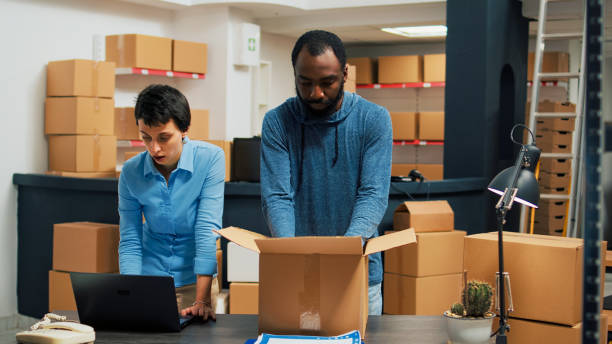 istock Business owners giving highfive after putting products in cardboard boxes 1454007791