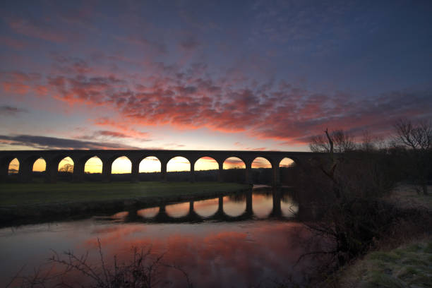 istock Arched bridge over the river at scenic sunset 1454007869