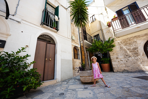 Baby girl tourist in street Bari, Puglia, South Italy.