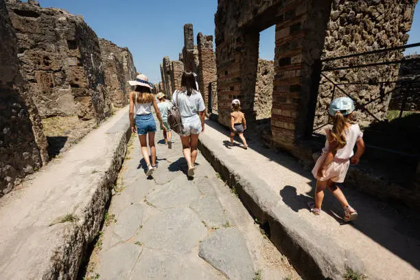 Photo of Family tourist walking at Pompeii ancient city, Italy.