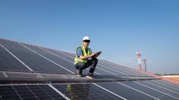 istock Service engineer checking solar cell on the roof  for maintenance if there is a damaged part., Clean energy concept. 1454009474