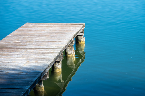 Tranquil scene of wooden pier and lake.