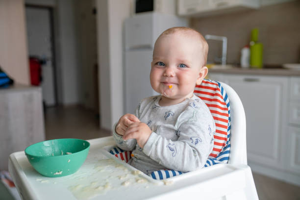istock Joyful baby after meal at the dinner table 1454012069
