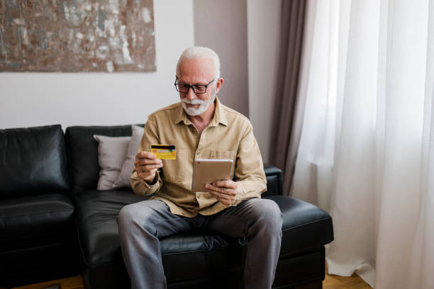 istock Senior man making online shopping on e-commerce website 1454012549