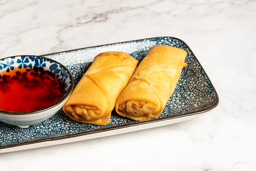Fried spring rolls with sweet chili sauce on plate. Typical Asian food. High quality photo