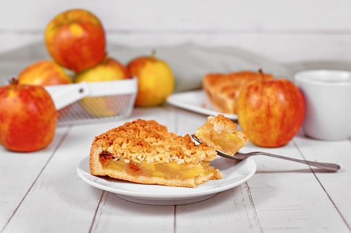 Slice of traditional European apple pie with topping crumbles called 'Streusel'