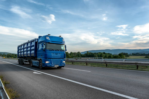 istock Big Blue truck driving on the highway 1454015409