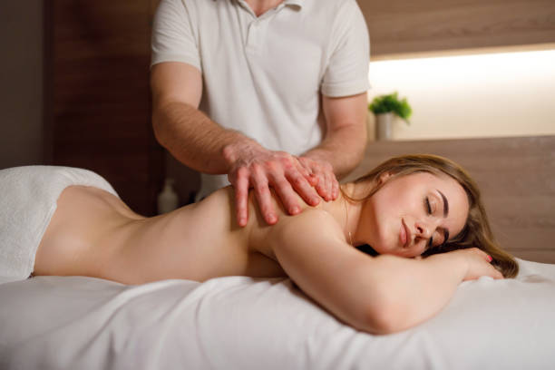 istock Spa. The girl is given a massage in the lower back 1454016577