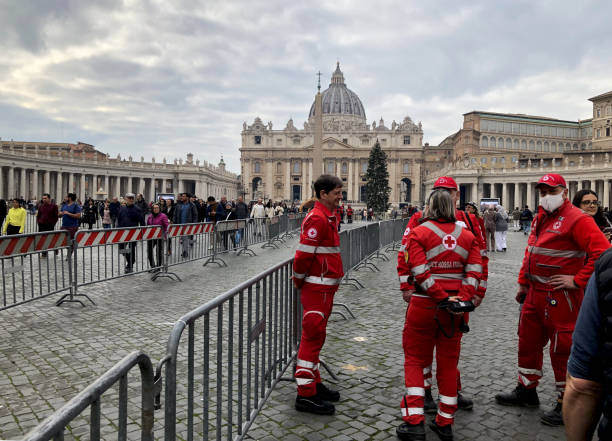Rome, Italy - January 3 2023 St.Peter Basilica - Pope Benedict funeral. Red Cross workers attending visitors in the square