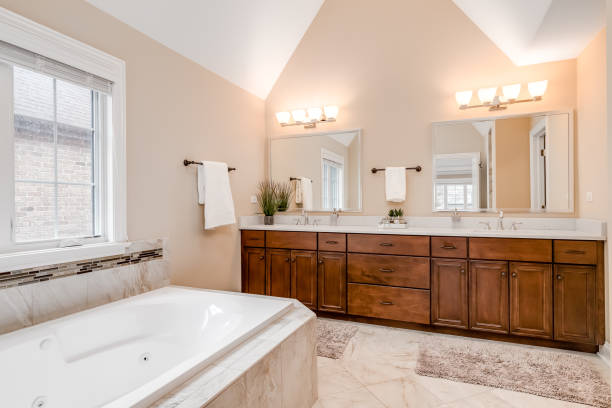 istock A bathroom with a large wood vanity and bathtub. 1454018524