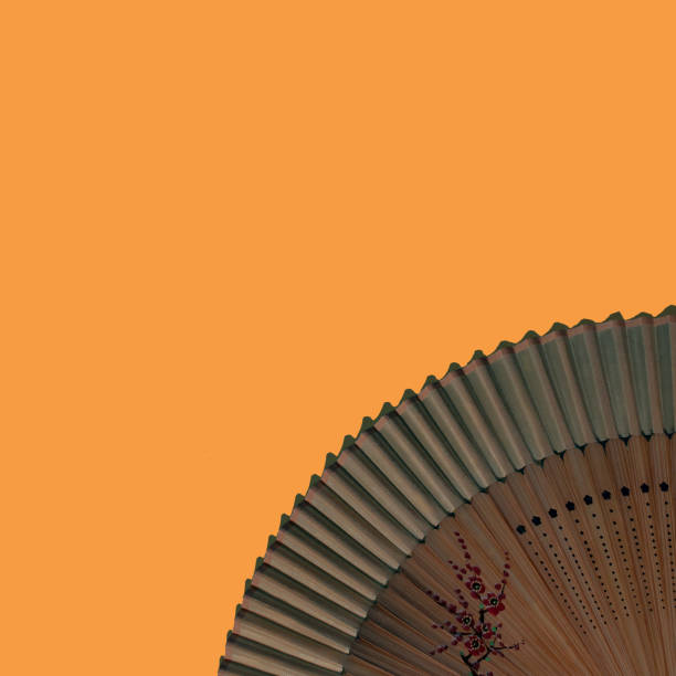 Sun shining through Japanese decorated wooden fan