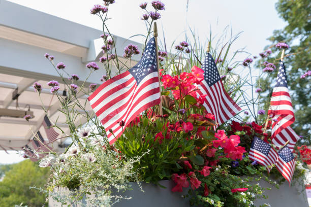 American flags interspersed among summer flowers in Chatham, Massachusetts, United States