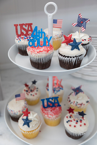 Close-up of Fourth of July themed cupcakes on display stand in Chatham, Massachusetts, United States