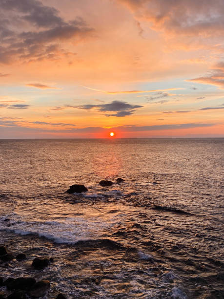istock colorful sunset at sea with rocks 1454021738