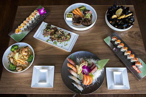 Overhead view of asian speciality dishes including sushi and sashimi in Chatham, Massachusetts, United States