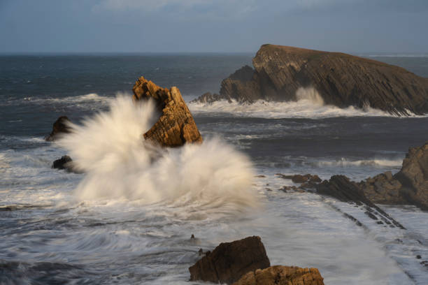 istock Large winter waves crash at Playa de la Arnia, Cantabria, Spain 1454021939