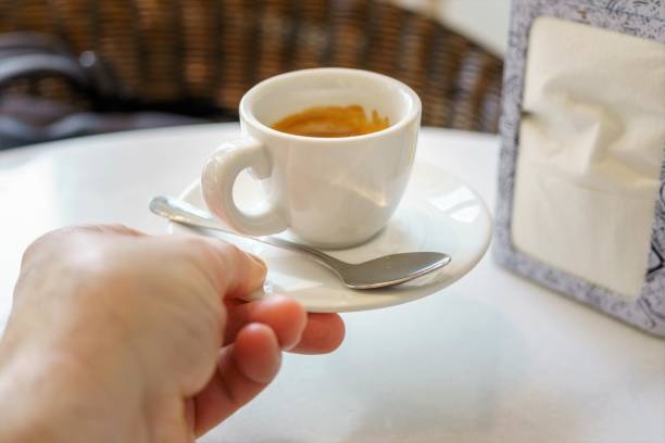 istock A white cup of espresso coffee on a plate with a spoon in a cafe. Copy space 1454024406