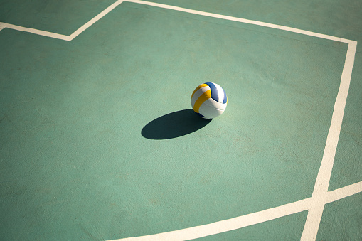 Volleyball ball flying in macro water drops and splashes isolated on black background. Concept of motion, action in sport, competition, speed of game. Copyspace for ad. Highly detailed.