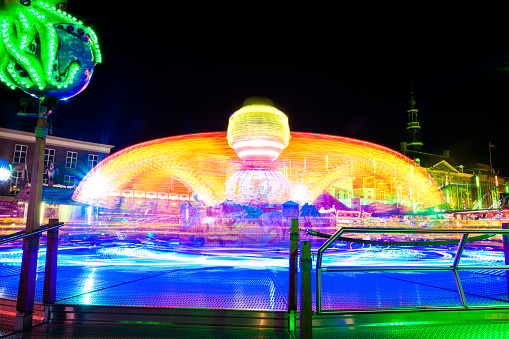 merry go round swing at night with colorful light at city fair ground from different angle