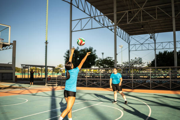 istock Female volleyball players training during warm-up before the match 1454024916