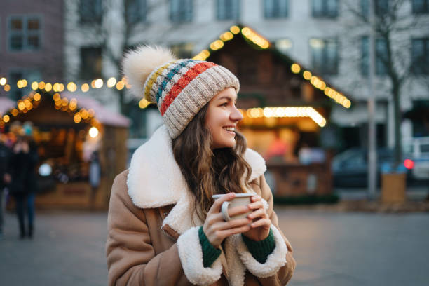 Happy smiling woman  having fun at the Christmas market Happy smiling woman  having fun at the Christmas market mulled wine stock pictures, royalty-free photos & images