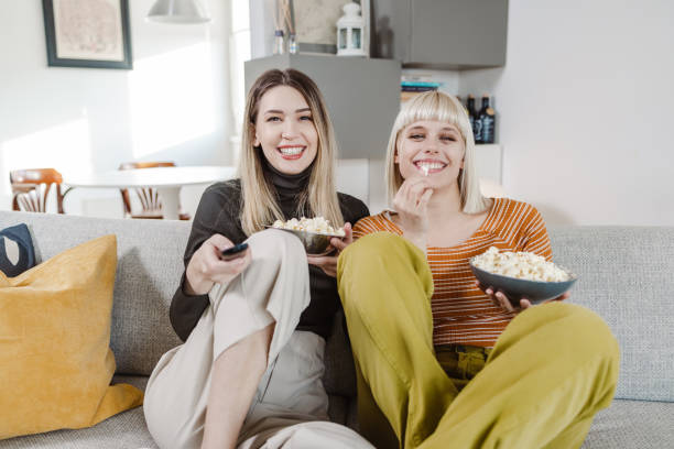 istock Young people watching TV at home 1454027289