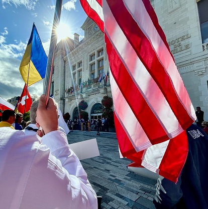US and Ukraine Flags In  Montlucon, France - 8/7/21: Part of a US flag and Ukrainian flag at the WGC opening ceremonies, Montlucon, France.