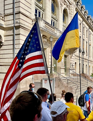 US and Ukraine Flags in  Montlucon, France - 8/7/21: US flag and Ukrainian flags at the WGC opening ceremonies, Montlucon, France.