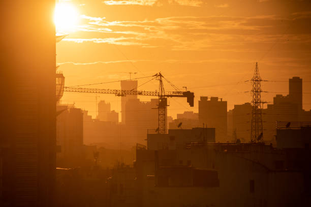 istock Silhouette of a construction crane on a building at sunset 1454028860
