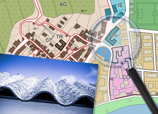istock Mapping roofing with asbestos-containing material - concept with a magnifying glass against an imaginary city map 1454030179