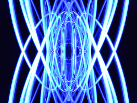 A abstract smooth sinusoidal blue lines on a dark background