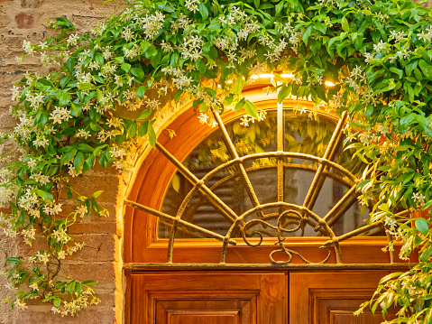 Door and window features of apartments along the streets of Pienza in Tuscany Italy at dusk