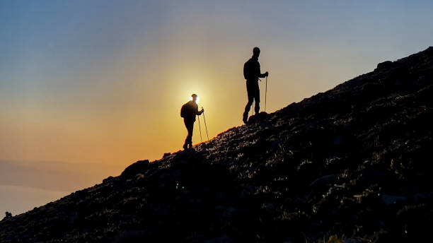 istock two friends mountaineering trek 1454036043