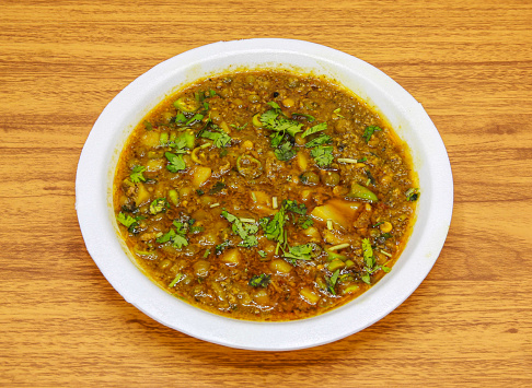 Aloo matar keema served in plate isolated on table top view of indian and pakistani spicy food