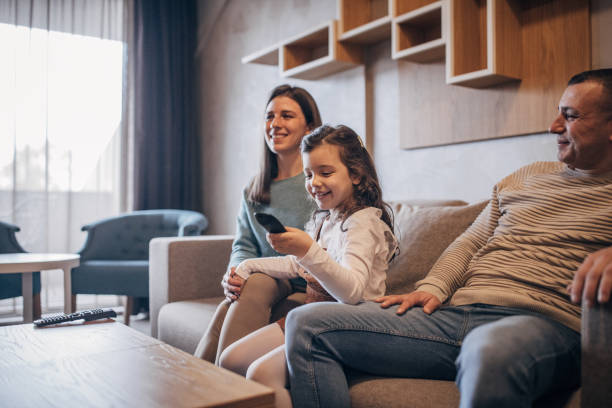 istock Family watching TV 1454038370