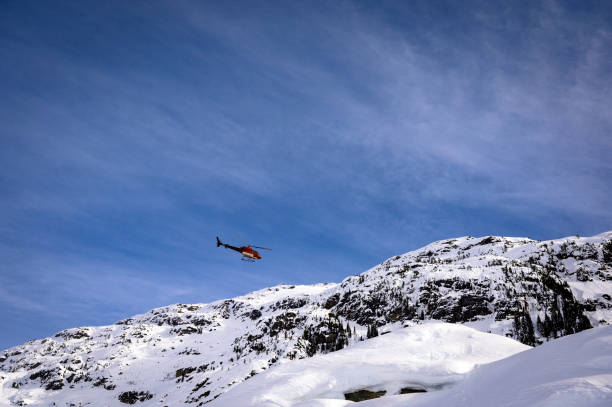 istock Helicopter flying in the mountains 1454039214