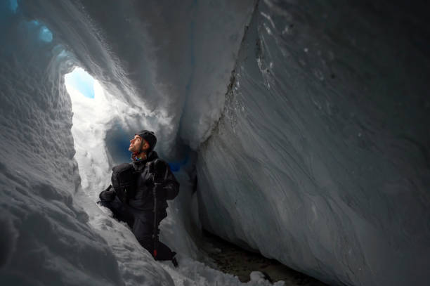 istock Photographer inside a glacial ice cave 1454039282