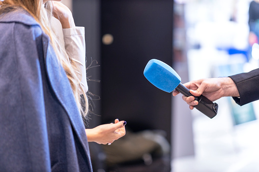News journalist making media interview with unrecognizable female person