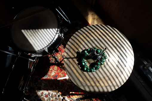 Hi-hat cymbals. Drum set in sunny room.