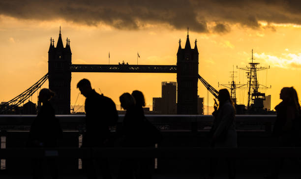 londoner pendler vor der tower bridge bei sonnenaufgang uk - london england tower bridge uk bridge stock-fotos und bilder