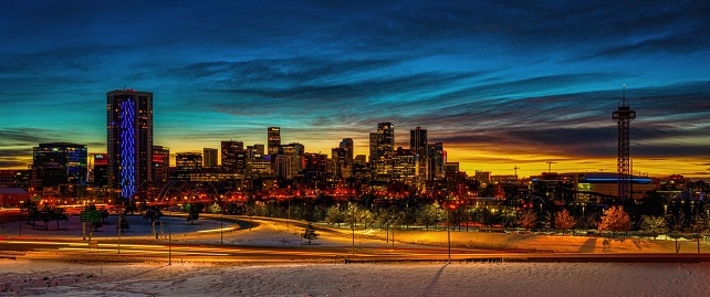 A panoramic shot of Denver cityscape in winter at sunrise, Colorado, USA.