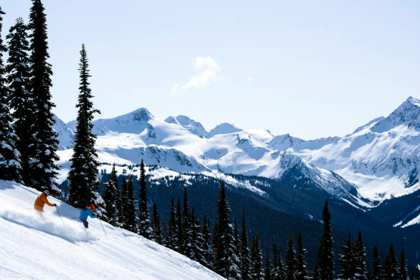 Couple on a ski vacation Best ski resorts in North America. Whistler ski resort in British Columbia. Couple bonding through winter sport. whistler mountain stock pictures, royalty-free photos & images