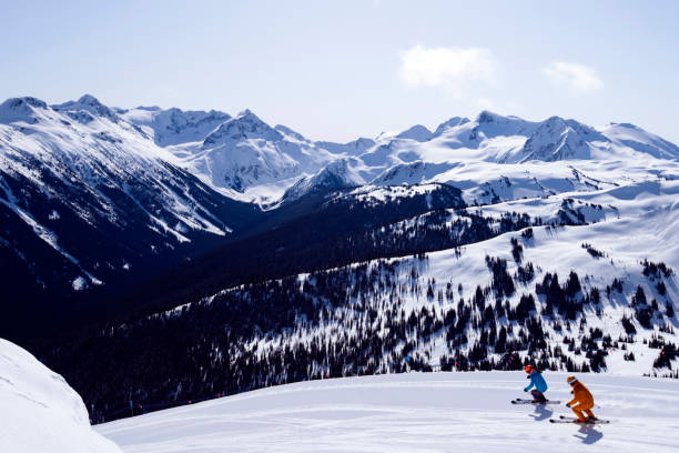 Couple on a ski vacation Best ski resorts in North America. Whistler ski resort in British Columbia. Couple bonding through winter sport. whistler mountain stock pictures, royalty-free photos & images