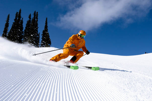 Skiing groomed runs in the mountains stock photo