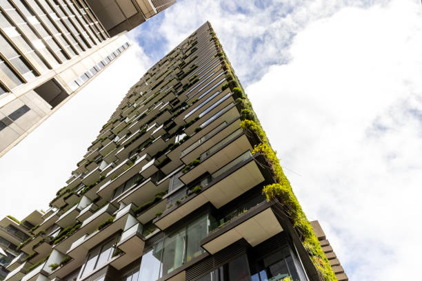 istock Low angle view of apartment building with vertical gardens, sky background with copy space 1454045536
