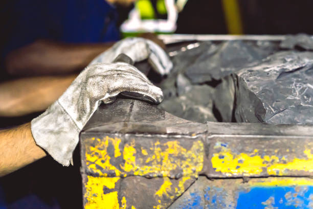 istock Close-up of a miner's hands working in a coal mine. 1454045723