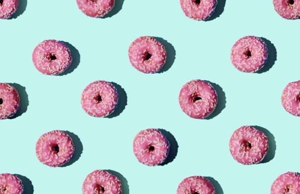 Pattern of donuts on green background stock photo