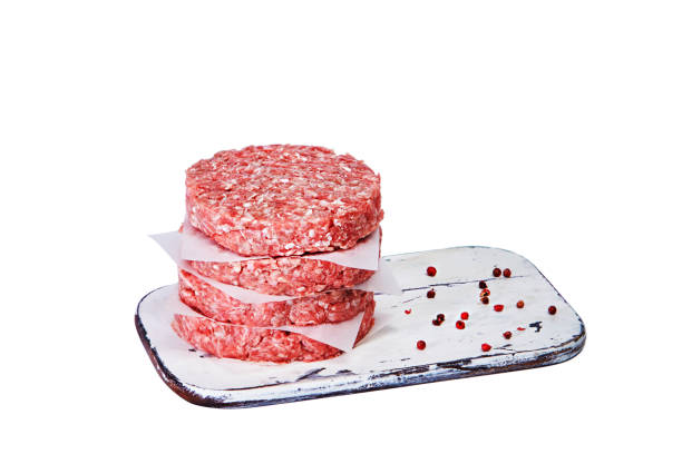 Raw hamburger meat isolated on wooden board on white background stock photo