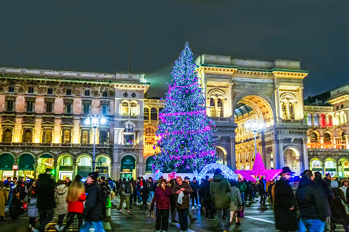 12-10-2022  Milan, Italy.  Christmas tree in Milan on Dom Square (Piazza Duomo)  in night and behind - Gallery of Victor Emmanuel II Soon - Christmas week and people-happy!